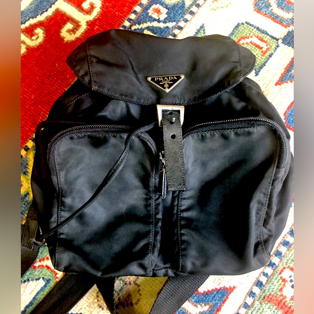 Prada nylon backpack authentic in good condition. Tears on the front straps.